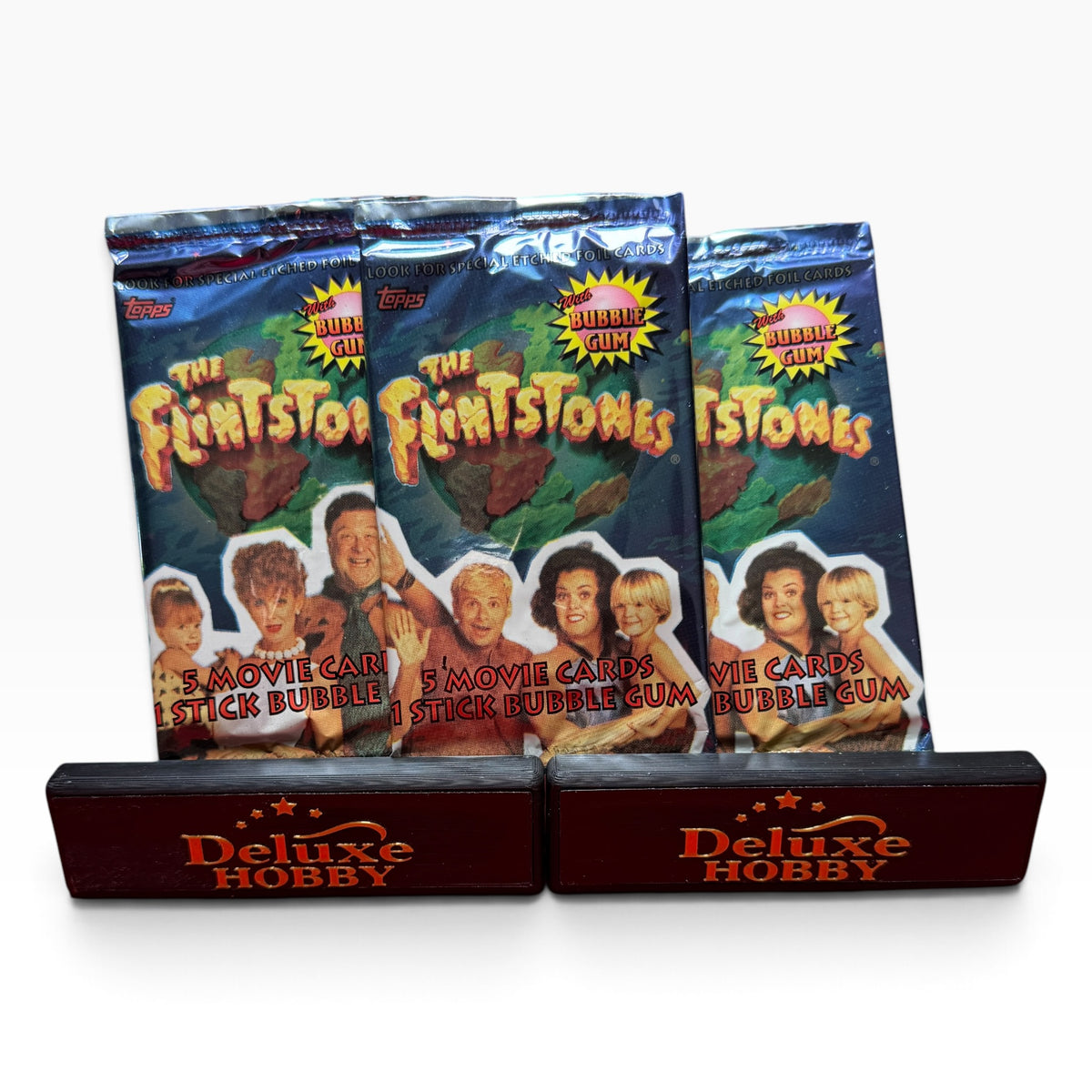 Three sealed 1994 Topps The Flintstones Movie trading card packs